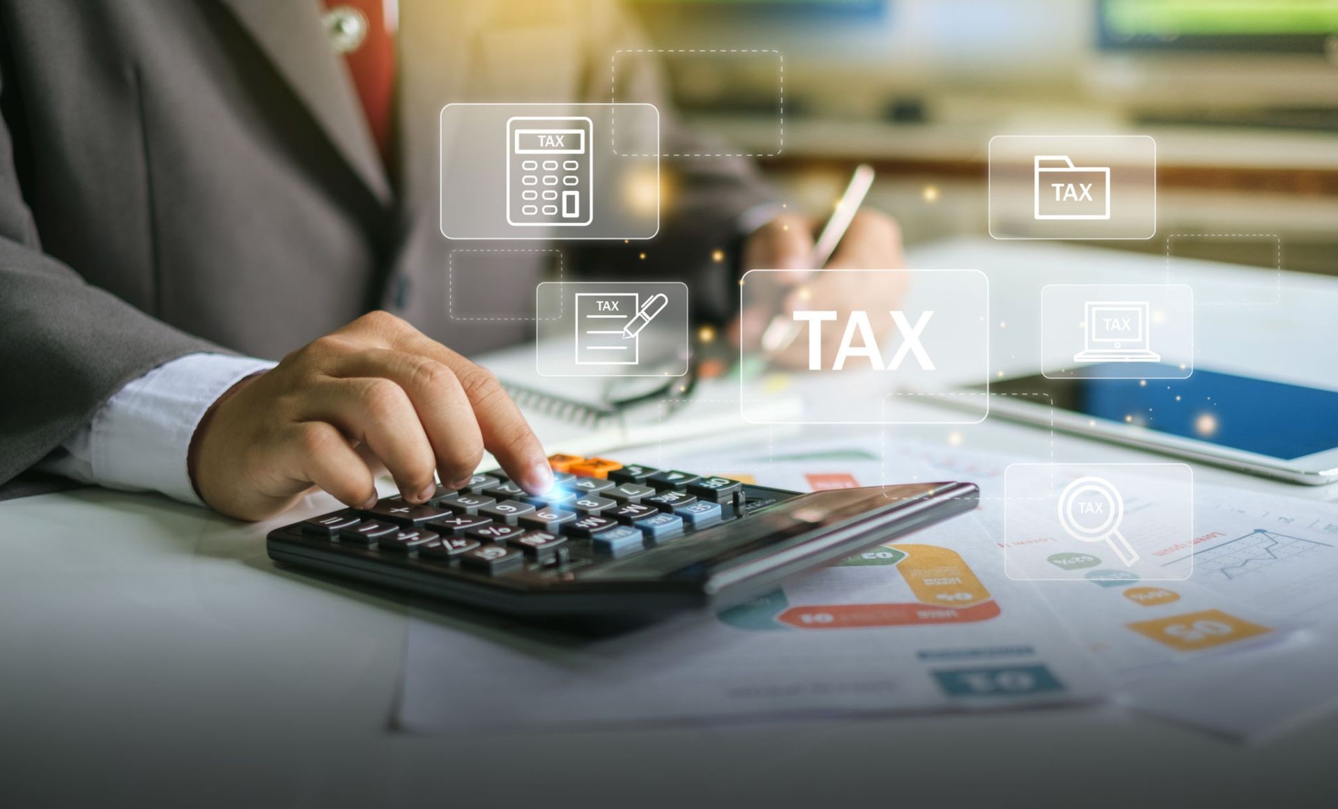 Finger pressing keys on a calculator with images of floating tax documents